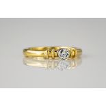 An 18ct yellow gold solitaire diamond ring, the brilliant cut diamond measuring approximately 0.