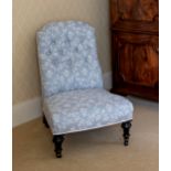 A Victorian slipper back nursing chair, well reupholstered in buttoned pale blue and white fabric,