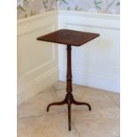 An early 19th century rosewood tripod table, the square top on a turned column to swept supports,