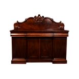 A Victorian mahogany double pedestal sideboard, the shaped flame mahogany back with foliate scroll