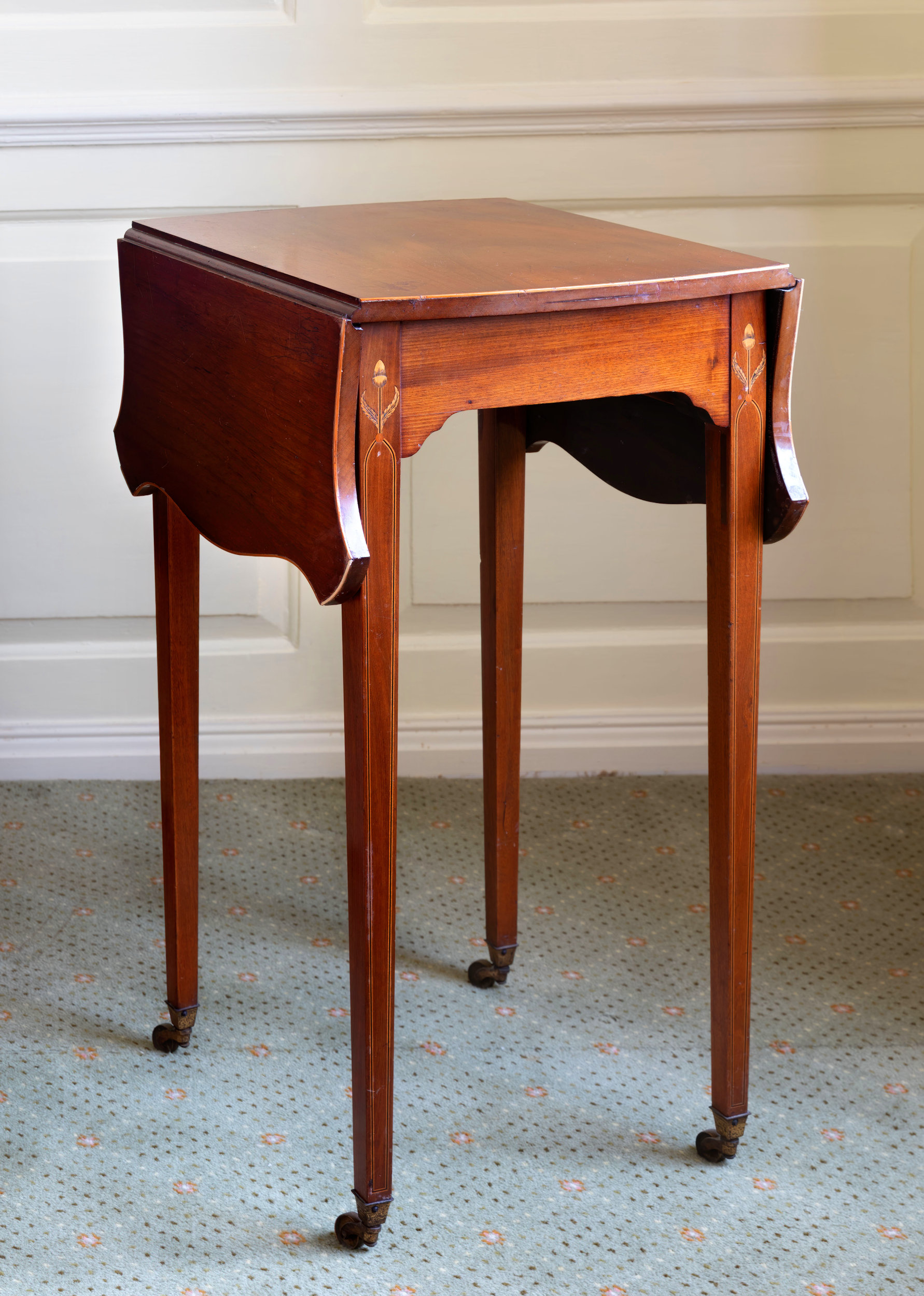 A small late-19th century mahogany Pembroke table, the shaped top with serpentine dropflaps,