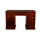 A Victorian mahogany desk, the moulded top with later rexine writing surface, over three frieze