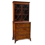 A George III mahogany secretaire bookcase of small proportions, the flared cornice over a pair of 13