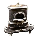 An antique Swiss multi-fuel cast iron wood burning stove, late-19th / early 20th century, blacked