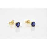 A pair of 18ct yellow gold and sapphire stud earrings, the round cut sapphires held in a 4 pronged