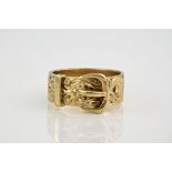A 9ct yellow gold buckle ring, with ornate scrolling to the metal work. Ring size T 1/2.
