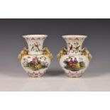 A pair of German Meissen style porcelain vases with goat's head handles, decorated with a courting