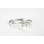 An 18ct white gold and diamond single stone ring, the emerald cut diamond weighing approximately 0.