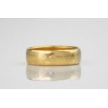 A 22ct yellow gold wedding band, measuring approximately 5mm wide. Ring size M1/2.