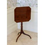 A George III mahogany tilt-top tripod table, the octagonal top on a turned baluster column with