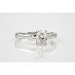 An 18ct white gold and oval cut diamond solitaire ring, the diamond weighing approximately 1.01ct