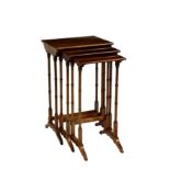 An Edwardian George III style nest of three tables, the boxwood and ebony strung tops raised on ring