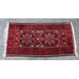 A Turkoman rug, the dark blue field with two pendant medallions and all over geometric and floral