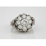 A vintage 18ct white gold and diamond cluster ring, the central brilliant cut diamond, approx. 1.