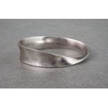 A Georg Jensen silver twist bangle, of smooth, polished silver and oval shape, measuring