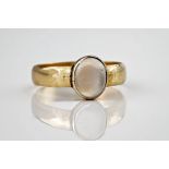 An antique 18ct yellow gold and moonstone ring, the central stone measuring approximately 10x8mm,