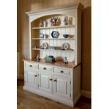 A painted pine and oak dresser, late 20th century, the flared, ogee cornice over an arched, closed