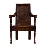 A 17th century and later oak Wainscot chair, the rectangular panelled back with a carved bas