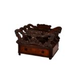 A William IV rosewood three division Canterbury, the pierced and foliate and scroll carved