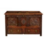 An early 18th century carved oak three panel mule chest, the three panel top on the original split