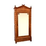 A Victorian faux-bamboo satin walnut wardrobe, the peaked top with turned finials, over a bevelled