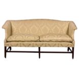 A George III mahogany camel back settee, late 18th century, the serpentine back over scroll arms and