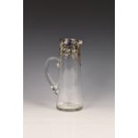 An Art Nouveau clear glass water jug with floral silver plated mounts, late Victorian, of