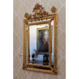 A 19th century French giltwood mirror, the rectangular bevelled plate within a foliate, cabochon and