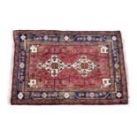 A small Kurdish Kolyai rug, second half 20th century, the two ivory geometric pendant medallions and