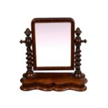 A Victorian mahogany swing mirror, with barleytwist turned uprights and serpentine base, 22½in. (