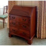 A George III mahogany bureau, of small proportions, the fall enclosing a fitted interior with