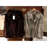 A short dark brown mink jacket, together with a dark grey rabbit fur short jacket, both size 10-