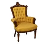 A late Victorian walnut small armchair, the flared, button back and bowfront seat upholstered in
