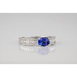 An 18ct white gold, diamond and tanzanite ring, the central, oval cut tanzanite measuring