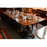 A good quality George III style solid mahogany two-pillar dining table, with two additional