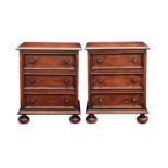 A pair of late-Georgian style three drawer mahogany bedside cabinets, second half 20th century, with