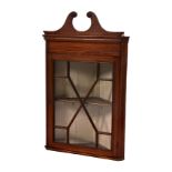 An Edwardian George III-style inlaid mahogany glazed corner cabinet, the boxwood strung swan neck