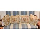 A set of four embroidered cushions with roses, 13¾in. (35cm.) square. (4)