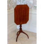 A mid-19th century mahogany tilt-top tripod table, the octagonal moulded top on a turned column to