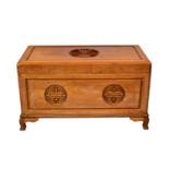 A mid-century Oriental camphorwood chest, decorated with carved Shou symbols, the panelled top