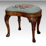 A George I style walnut kidney shaped stool, circa 1900, the drop in petit point floral seat