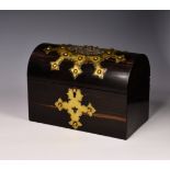 A Victorian gilt brass bound coromandel wood box, the domed top box with gilt brass strapwork