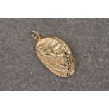 A 9ct yellow gold pendant in the shape of an ormer, measuring 32x22mm and weighing approximately