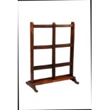 A mid-19th century mahogany folding towel rail, the three bar rails on a platform base with scroll