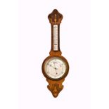 An Edwardian walnut and marquetry aneroid wheel barometer, with 7½in. silvered dial and mercury