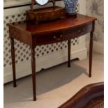 A George III mahogany break bowfronted side table, the satinwood cross banded top over a single