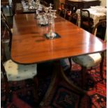 A Regency style twin pedestal mahogany dining table, mid-20th century, with two additional leaves