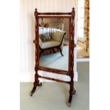 A late-Regency mahogany cheval mirror, the rectangular plate within a baluster turned frame, on