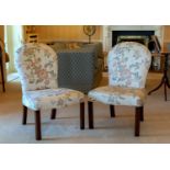 A pair of 18th century mahogany upholstered chairs, the balloon backs over serpentine stuff over