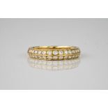 A 9ct yellow gold and diamond double row ring, featuring 26 round cut diamonds in 2 symmetrical rows